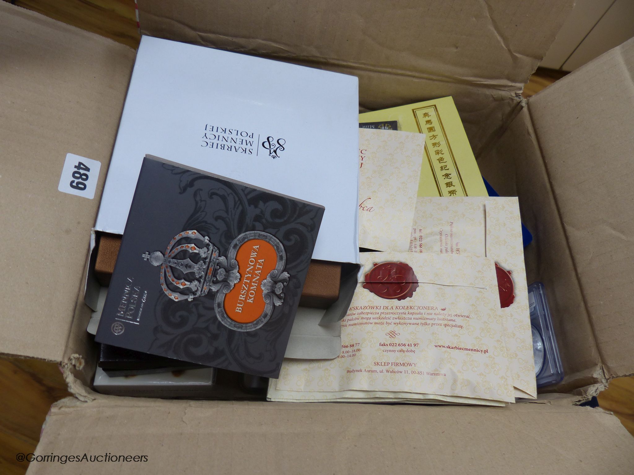 A box of assorted collectors coins and medallions.